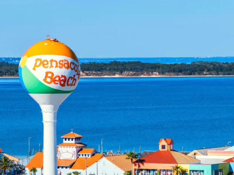 A water tower with the words pensacola beach on it.